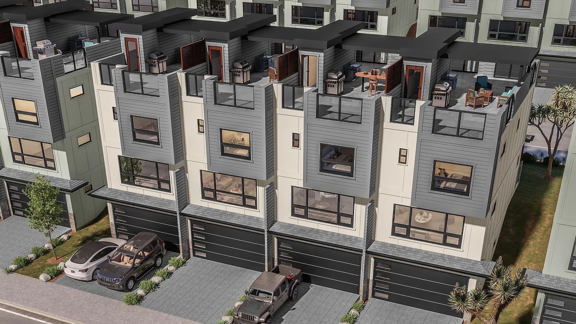 Elevated rear view of townhouses with garages and rooftop decks